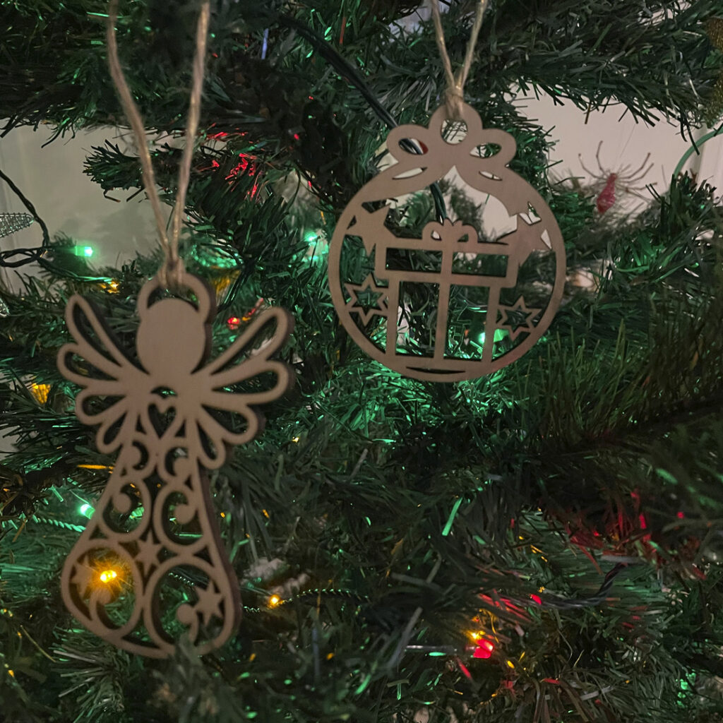 Image of various Christmas decorations on a tree by Seeds to Sow